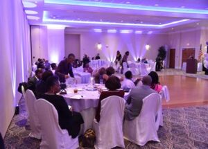 A group of people sitting at tables in a room.