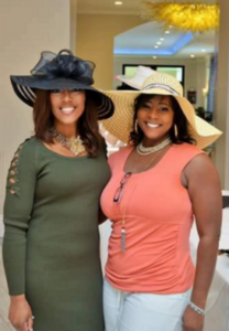 Two women in hats posing for a picture.