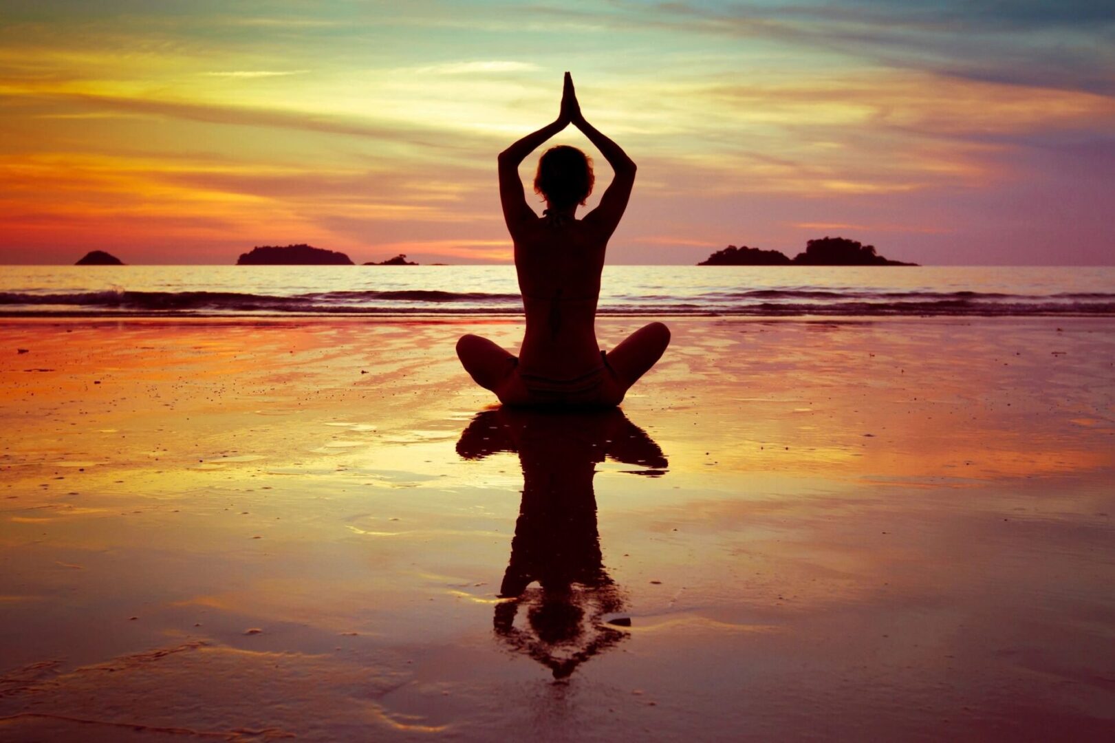 A person sitting in the water doing yoga.