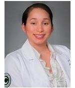 A woman in white lab coat smiling for the camera.